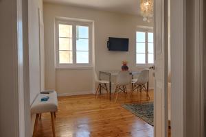 a living room with a dining room table and chairs at Serene Sea View Apartment in Corfu Old Town in Corfu