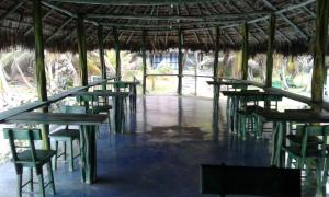 a group of tables and chairs in a pavilion at Bahia Lodge in Capurganá