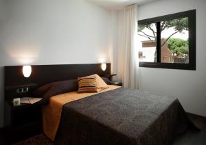 a bedroom with a bed and a large window at SG Marina 54 Apartments in Castelldefels