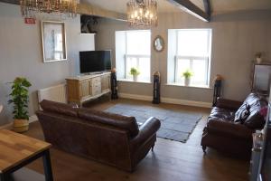 a living room with two couches and a television at Hide Hill, Berwick Upon Tweed in Berwick-Upon-Tweed