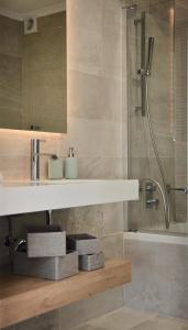 a bathroom with a sink and a shower at Aquamarine - Gemstone Getaway in Vale do Lobo