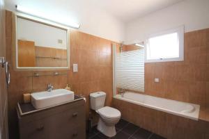 a bathroom with a toilet and a sink and a bath tub at Katerina in Ayia Napa +24 photos