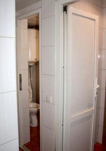 a bathroom with a toilet and a white door at Matras Hotel in Kyiv