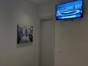 a television hanging on a wall in a room at Affittacamere Ca' Dei Lisci in Riomaggiore