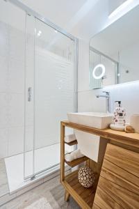 a bathroom with a sink and a shower at Hotel Garni & Appartementhaus Fichtenwald in Bad Füssing