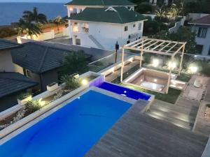 an aerial view of a house with a swimming pool at night at Luxe Life House in Durban