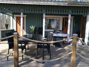 a deck with a table and chairs and a ping pong ball at ILO107 in Huhus