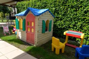a small toy house with a table and chairs at Borgo Ai Lecci in Orentano