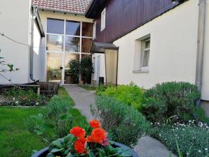 ラーデボイルにあるFerienwohnung Pohle-Priske Radebeulの花の家の前の庭