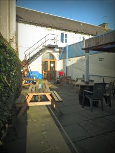 a patio with picnic tables and a stair case at Burntisland Sands Hotel in Burntisland