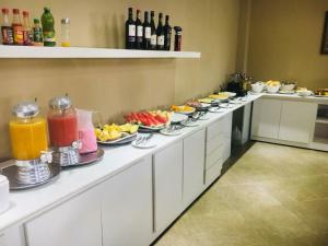 a kitchen counter filled with lots of different types of food at Lacazzona Hotel in Belo Jardim