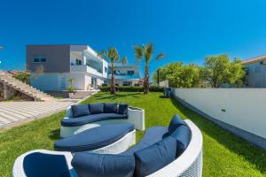 une cour avec deux canapés et une pelouse avec une maison dans l'établissement Luxury Apartments Marija, à Sukošan