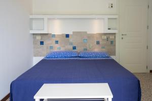 A bed or beds in a room at Locanda Villa Fiori