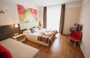 Ein Bett oder Betten in einem Zimmer der Unterkunft Harmonia Termal Hotel Sarvar