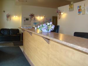 a bar with a vase of flowers on the counter at Hotel Quartier Latin in Montreal