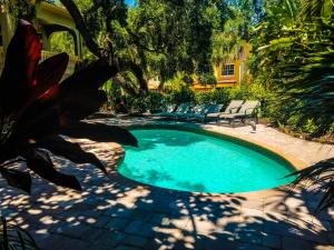 a small swimming pool in a yard with a tree at Siesta Key Beach House in Siesta Key