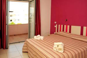 two beds in a room with towels on them at Hotel La Punta in Otranto