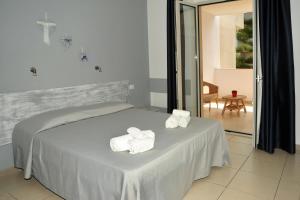 Postel nebo postele na pokoji v ubytování Hotel La Punta