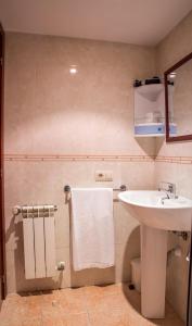 a bathroom with a white sink and a mirror at Hostal Hotil Coruña Centro in A Coruña