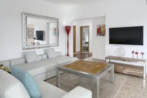 a living room with a white couch and a table at Can Garchet White Ibiza in Sant Jordi