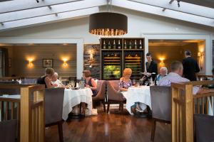 people sitting at a table in a restaurant at Rothay Garden Hotel & Riverside Spa in Grasmere