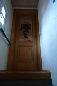 a wooden door with a stained glass window on it at Jocklerturm in Sulzfeld am Main