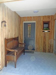 a wooden bench sitting in front of a door at Schloss Stiege in Stiege