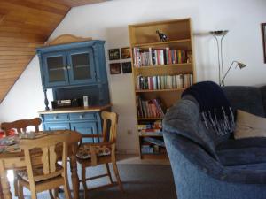 トラーベン・トラーバッハにあるFerienwohnung Lydiaのリビングルーム(青いソファ、ダイニングテーブル付)