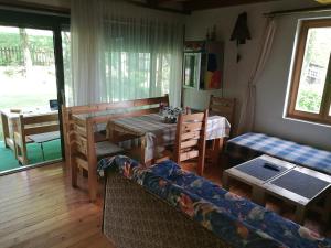 a living room with a table and a couch at Apartment Dulovine in Kolašin