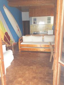 a living room with a couch and a surfboard on the wall at Villa Nelly by the sea in Néa Koróni
