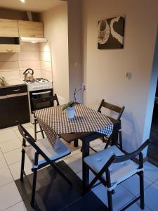 a dining room table and chairs in a kitchen at Kwatera prywatna in Augustów +2 photos