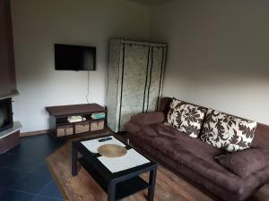 a living room with a couch and a coffee table at Kwatera prywatna in Augustów