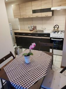 a kitchen with a table with a flower on it at Kwatera prywatna in Augustów
