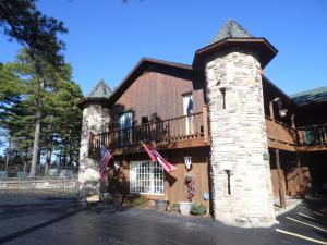 a log home with a tower and a balcony at Country Mountain Inn in Eureka Springs