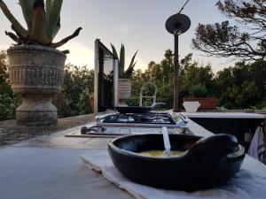 a kitchen with a stove and a bowl of soup at Villa Eugenia in Livorno