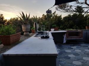 an outdoor kitchen with a stove and a counter top at Villa Eugenia in Livorno