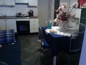 a kitchen with a table with a vase of flowers on it at Appartamento Libertà in Portovenere