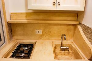 A kitchen or kitchenette at Ricciolandia Suites