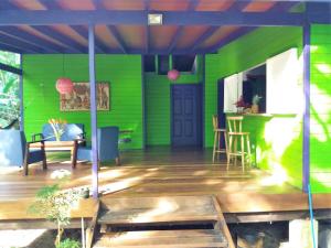 a green house with a table and chairs at El Tucan Jungle Lodge in Puerto Viejo