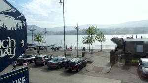 a group of cars parked in a parking lot near a body of water at The Lough and Quay in Warrenpoint