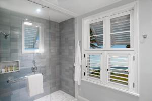 a bathroom with a shower and a window at Half Moon in Montego Bay