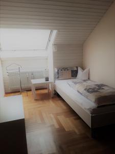 a bedroom with a bed and a large window at Ferienwohnung Bieniussa in Gemünden