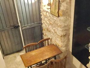 a wooden table and chairs in front of a window at Cluny La Sorbonne Paris in Paris