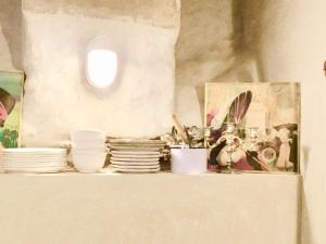 a shelf with plates and other dishes on it at Cluny La Sorbonne Paris in Paris +41 photos