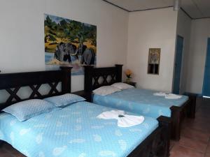 Postel nebo postele na pokoji v ubytování Hotel La Uvita