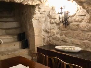a dining room with a table and a stone wall at Marais Romantique Paris centre 4 chambres in Paris +122 photos