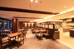 a restaurant with wooden tables and chairs in a room at Shimobe Hotel in Minobu