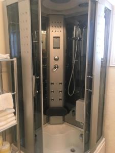 a shower with a glass door in a bathroom at Capri Beach Hotel in Corpus Christi +154 photos
