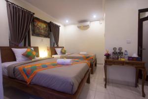Postel nebo postele na pokoji v ubytování Nengah House Ubud
