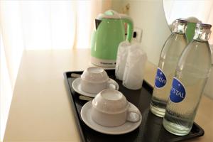 a tray with two cups and bottles on a table at Lucky Green View in Bangkok +24 photos